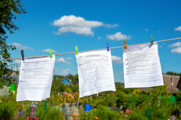 The documents tax forms were washed and dried in the open air by hanging from a clothesline. Concepts of money laundering, legalization of income, concealment of income, tax evasion.