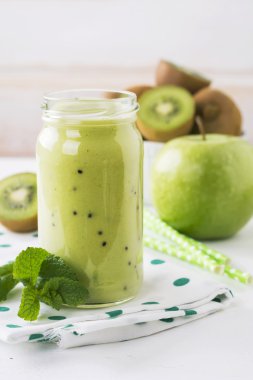 Taze ev yapımı kivi suyu beyaz zemin üzerine cam kavanozda.