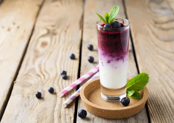딸기와 민트 유리에 신선한 건강 한 블루베리 스무디는 나무 스탠드에 나뭇잎. 선택적 초점. — 스톡 사진