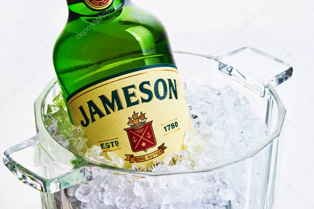 MOGILEV, BELARUS JANUARY 23 2021: Bottle of Jameson, the bestselling Irish whiskey in the world in nice cooling bucket with ice isolated on white background.