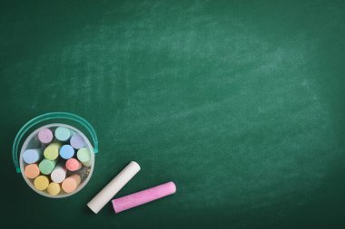 Color chalk pencil on green school board. Concept back to school. Mock up for design. Copy space. Education Concept.