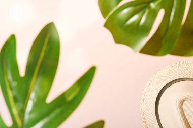 Yaz Denizi Tatil Arkaplanı. Plaj kumu taklidi, erkek hasır şapka, yaprakların ve ağaçların derin gölgeleri. Güneşli bir gün. Üst görünüm.