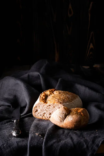 Čerstvě Upečený Domácí Kyselý Chléb Tmavém Lněném Ubrousku Dřevěné Zázemí — Stock fotografie