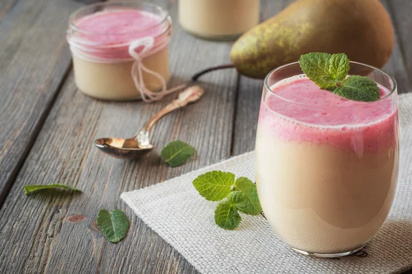 Pear smoothie with red current and mint leaf on an old wooden table background.Selective focus. — Stock Photo, Image