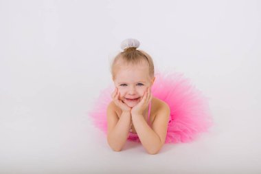 Pembe elbiseli küçük bir kızın portresi beyaz bir arka planda etekli ve kısa mesaj için yeri olan.