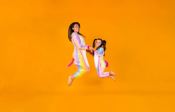 Funny Girls Plush Pajamas Jump Yellow Background Place Text — Stok fotoğraf