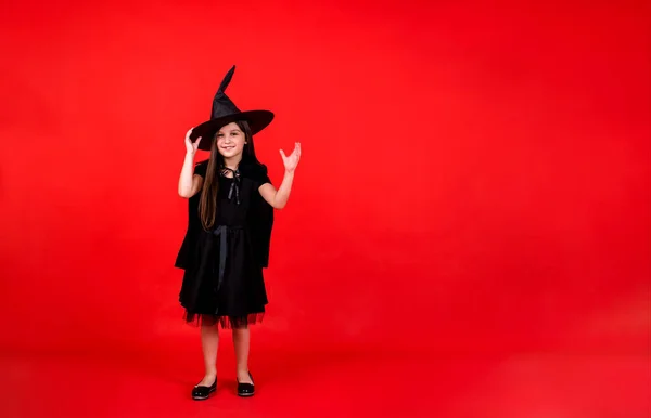 Little Girl Witch Costume Hat Stands Red Background Copy Space — 스톡 사진