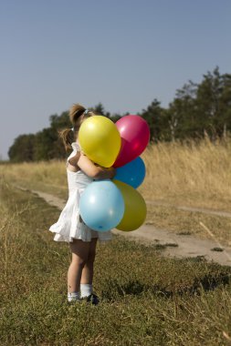 the girl in the field with balloons