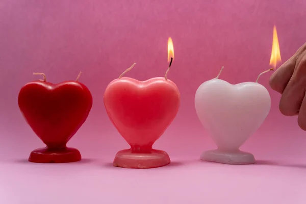 Person Lighting Candles Shape Heart Pink Background Love Friendship Day — Stock Photo, Image