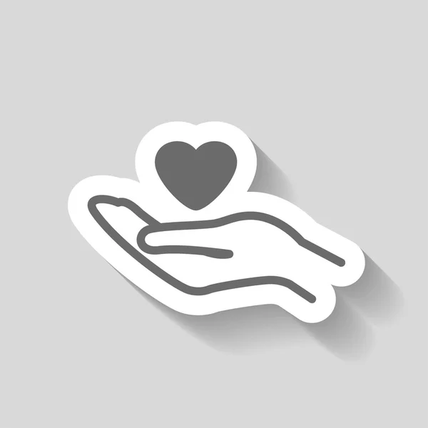 Corazón en la mano icono — Vector de stock