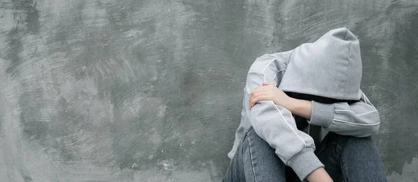 Depresyonda ve umutsuz genç kız uyuşturucu kullandıktan sonra yalnız oturuyor ya da beton duvarın üzerinden sarhoş içki içiyor. Uyuşturucu bağımlılığı ve yoksunluk belirtileri konsepti. Uyuşturucu Bağımlılığına Karşı Uluslararası Gün.