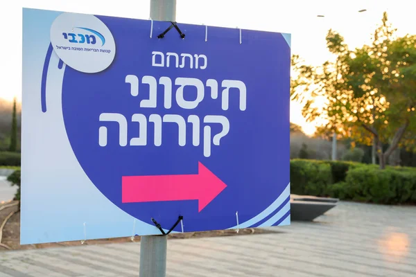 Haifa, Israel - 18 december 2020: Offentlig vaccinationsstation mot COVID-19 av Maccabi sjukvårdstjänster i Israel med tecken på hebreiska. — Stockfoto
