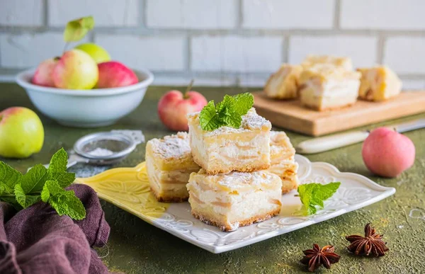 用酥皮糕点制成的切片苹果派 在绿色混凝土背景的正方形盘子上夹有奶酪奶油和苹果片 苹果派配方 感恩节 — 图库照片
