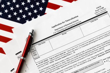 close-up of n-400 form. application for naturalization topview, on a background of United States flag. clipart
