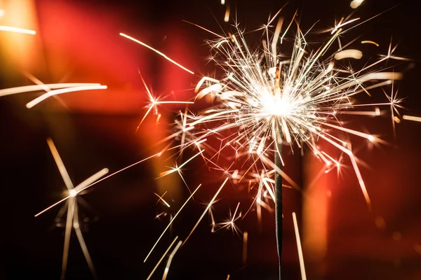 Sparkler on blurred background — Stock Photo, Image