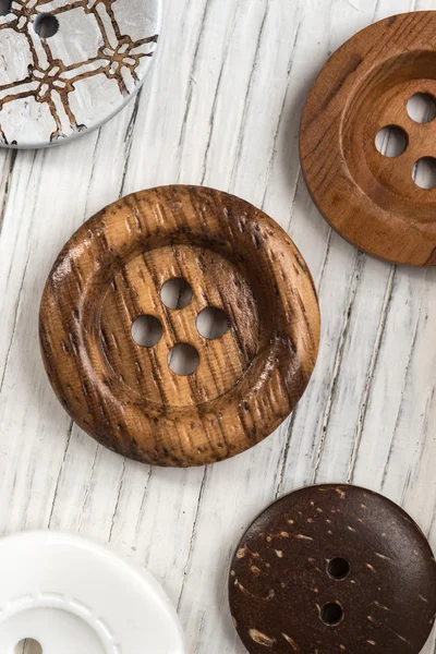 Buttons on wooden table — Stock Photo, Image