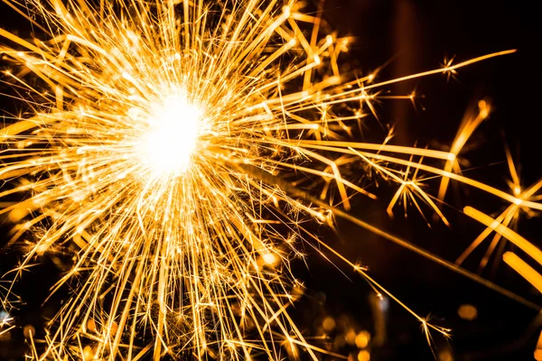 Sparkler on blurred background — Stock Photo, Image