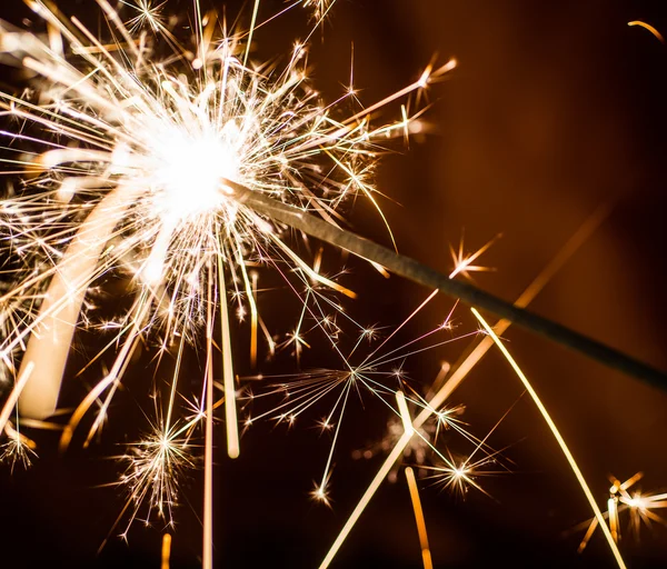 Sparkler on blurred background — Stock Photo, Image