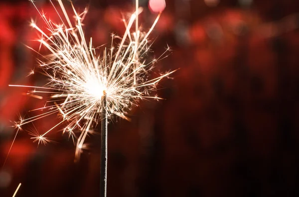 Sparkler on blurred background — Stock Photo, Image