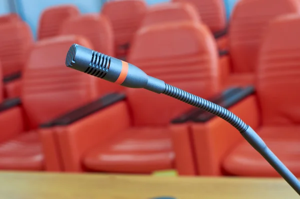 Microphone in front of empty chairs.