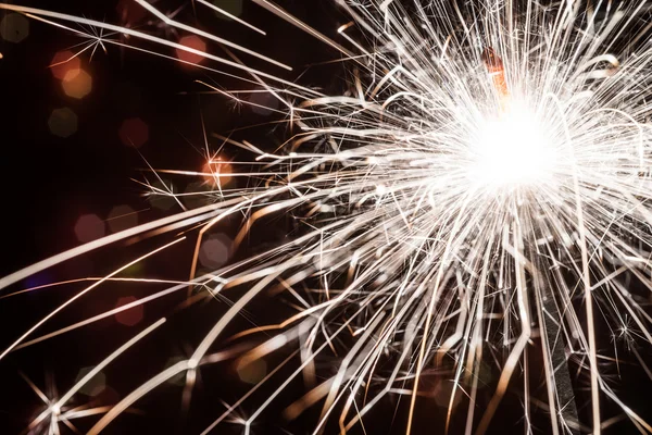 Sparkler on blurred background — Stock Photo, Image