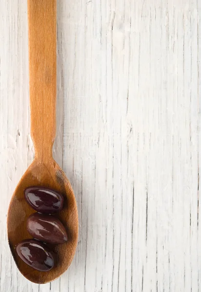 Olives in wooden spoon — Stock Photo, Image