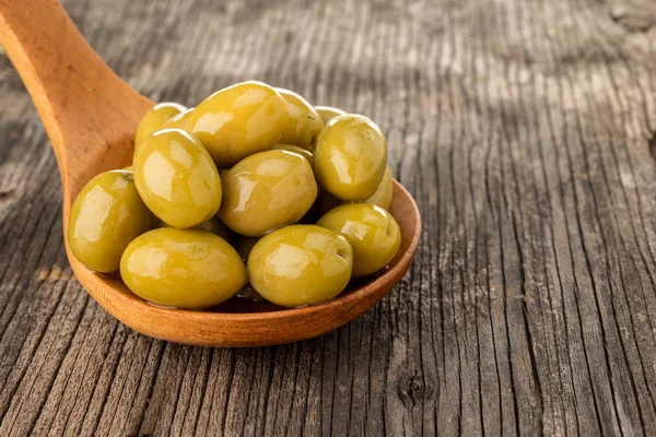 Olives in wooden spoon — Stock Photo, Image