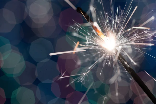 Sparkler on blurred background — Stock Photo, Image