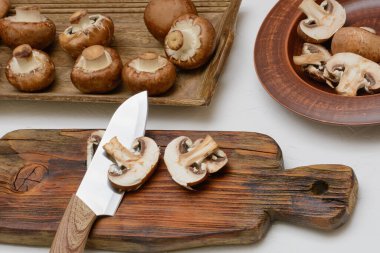 Brown royal champignons. Slicing mushrooms for cooking.