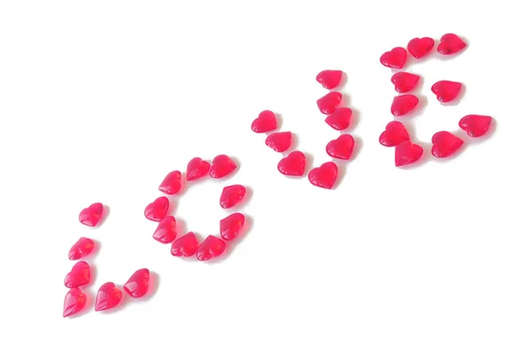 Corazones Rosados Vidrio Dispuestos Palabra Amor Diagonal Fondo Aislado Blanco — Foto de Stock