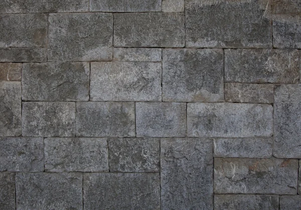 Parede de pedra antiga feita de pedra cinzenta retangular — Fotografia de Stock