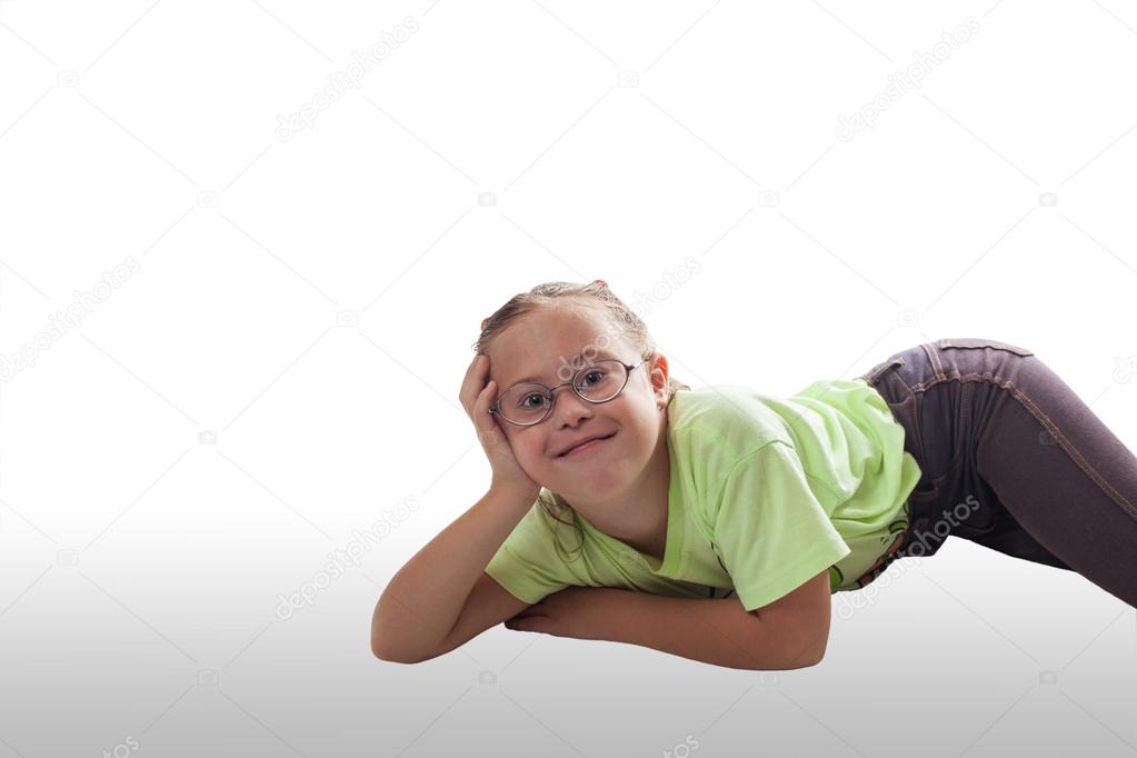 Lying horizontally girl with glasses in gray jeans