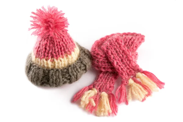 Cap, scarf, knitting kit for a kitten and dolls  on a light background Stock Photo