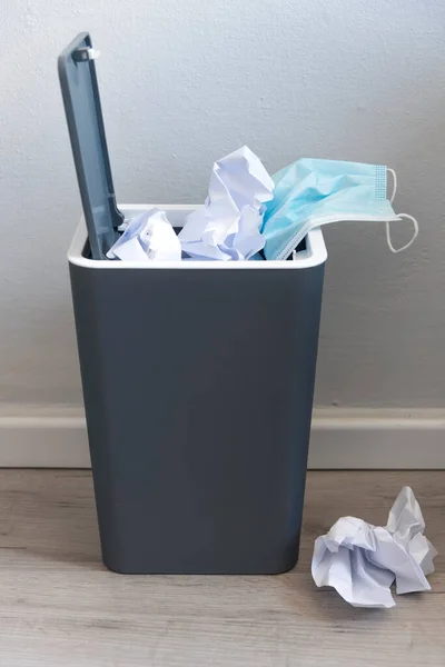Used surgical face mask in a blue bin. The masks used during the Corona Covid-19 virus epidemic were thrown away.