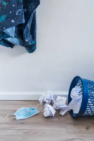 Used surgical face mask in a blue bin. The masks used during the Corona Covid-19 virus epidemic were thrown away.