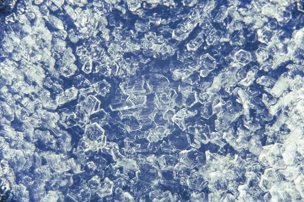 Macro close up of ice crystals on a blue background