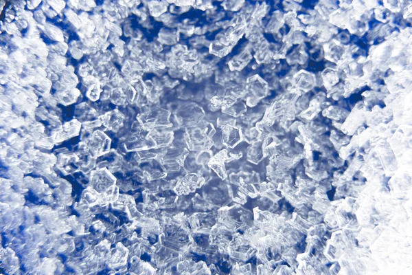 Macro close up of ice crystals on a blue background
