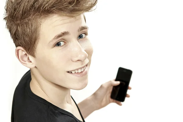 Adolescente sosteniendo teléfono inteligente y sonrisas — Foto de Stock