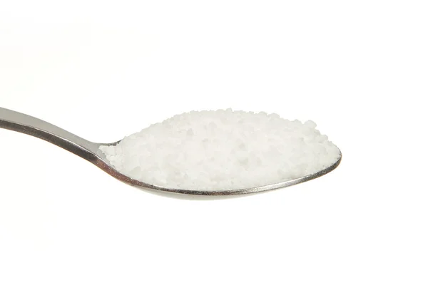 Salt (Sodium chloride) on a teaspoon — Stock Photo, Image