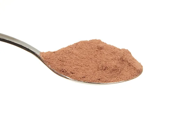 Cocoa powder on a teaspoon — Stock Photo, Image