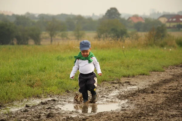 Little boy and puddles — Stock Photo, Image