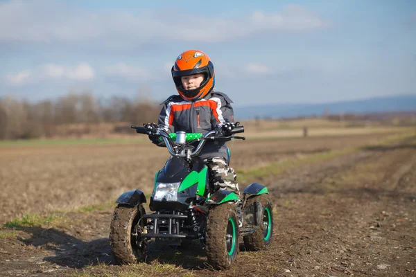 Boy rides on electric ATV quad. — Stock Photo, Image