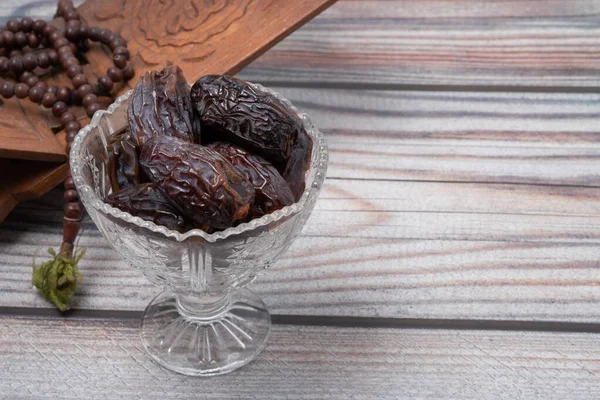 Ahşap zemin üzerinde kurumuş tarihler veya kurma Ramazan kavramı. 