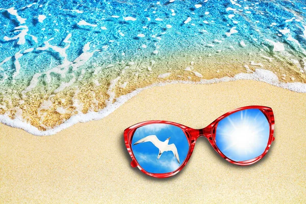 Blue sea wave, yellow sand beach, turquoise ocean water, red sunglasses, reflection, blue sky, shiny sun, flying white seagull top view closeup, summer holidays travel banner, tropical island vacation