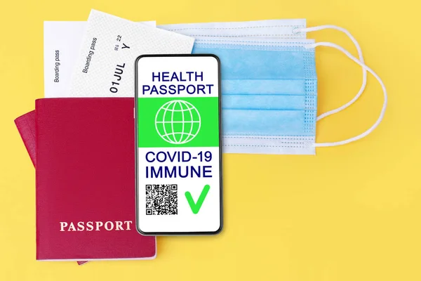 Digital health passport COVID 19 immunity coronavirus vaccination certificate, smartphone, flight boarding pass, protective medical face mask, vaccinated people travel summer holidays vacation tourism