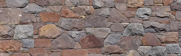 Texture of a stone wall. Old castle stone wall texture background. Stone wall as a background or texture. Part of a stone wall, for background or texture. can be used as wallpaper