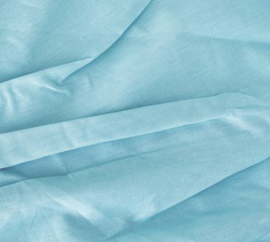 Mavi kumaşın ışık kıvrımlı dokusu.