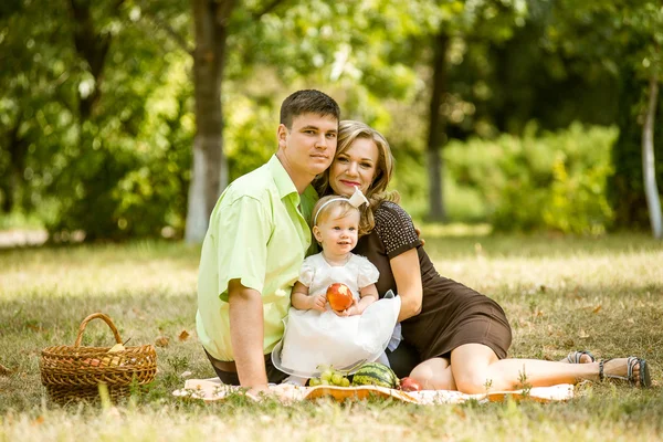 Happy family walking in the park Stock Picture