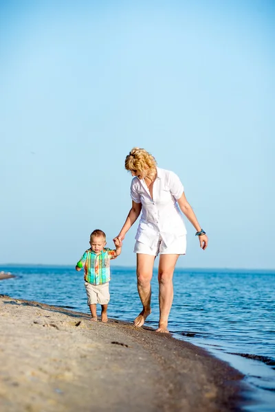 Mutter mit Kleinkind am Strand. — Stockfoto