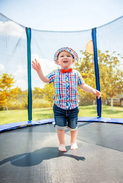 Kid jumping on a trampoline — Stock Photo, Image